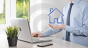 Real estate concept, businessman holding a house icon.House on Hand.Property insurance and security concept. Protecting gesture of