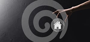 Real estate concept, businessman holding a house icon.House on Hand.Property insurance and security concept. Protecting gesture of