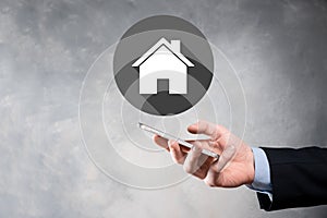 Real estate concept, businessman holding a house icon.House on Hand.Property insurance and security concept. Protecting gesture of