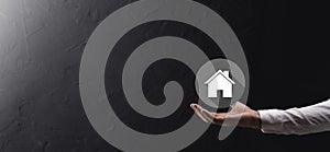 Real estate concept, businessman holding a house icon.House on Hand.Property insurance and security concept. Protecting gesture of