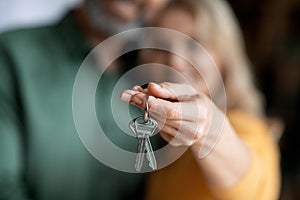 Real Estate Concept. Closeup Of Married Middle Aged Couple Holding Home Keys