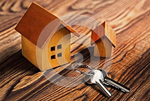 Real estate concept with house and key on wooden background. Idea for real estate concept, personal property an