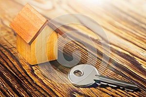 Real estate concept with house and key on wooden background. Idea for real estate concept, personal property a