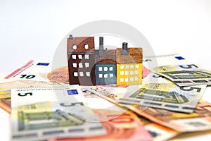 Real estate concept,house and money on white background.