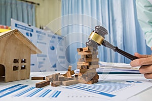 Real estate concept, prevent consultant urgent, wood toy building on business desk table in office.