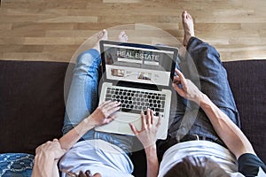 real estate concept on screen of computer, couple looking for apartment to rent