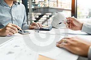 Real-estate concept, Two engineer and architect discussing blueprints data working and digital tablet on construction building