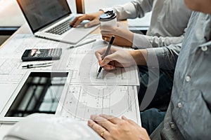 Real-estate concept, Two engineer and architect discussing blueprints data working and digital tablet on construction building