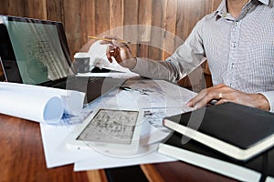 Real-estate concept, Two engineer and architect discussing blueprints data working and digital tablet on construction building