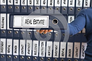 Real Estate concept. Young man holding ring binder.