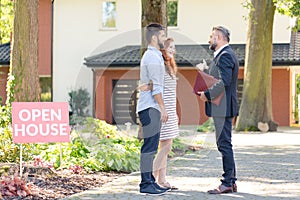 Real estate consultant inviting couple