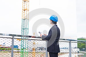 Real estate developer in helmet. New office construction. Confident business men or architect in front of office