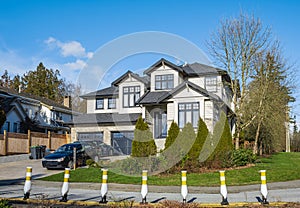 Real Estate Exterior Front House. Big custom made luxury house with nicely landscaped front yard and driveway to garage