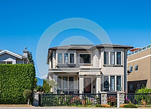 Real Estate Exterior Front House on a sunny day.Big custom made luxury house with nicely landscaped front yard in summer