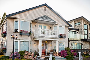 Real Estate Exterior Front House on a sunny day.Big custom made luxury house with nicely landscaped front yard in summer