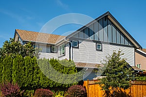 Real Estate Exterior Front House on a sunny day.Big custom made luxury house with nicely landscaped front yard in summer