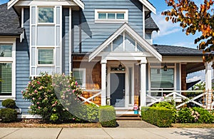 Real Estate Exterior Front House on a sunny day.Big custom made luxury house with nicely landscaped front yard in summer