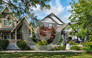 Real Estate Exterior Front House on a sunny day.Big custom made luxury house with nicely landscaped front yard in summer