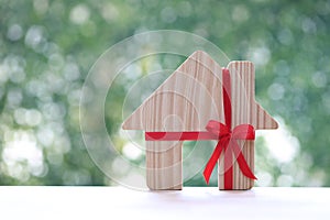 Real estate and Gift new home concept,Model house and red ribbon for Christmas and New Year\'s Day or Greeting season