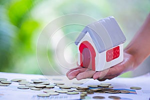 Real estate investment. House and coins on table