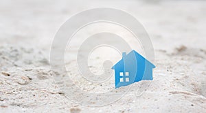 Real estate investment with Small home on sand.