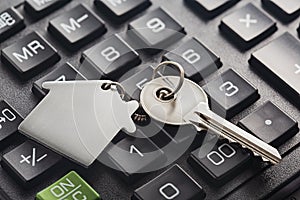 Real estate, keychain with house symbol. Calculator with finance blank