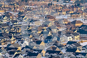 Real estate landscape with homes on a snowy neighborhood on a sunny winter day