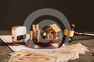 Real Estate Law concept. Wooden model of house, money and judge gavel on contract