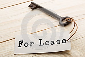 real estate lease concept - old key with tag