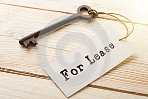 real estate lease concept - old key with tag