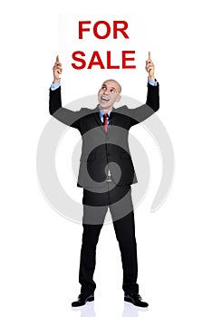 Real estate man holding a for sale sign