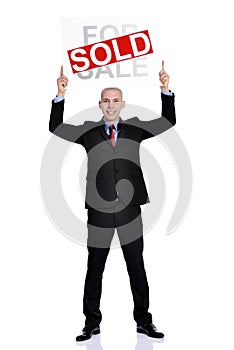 Real estate man holding a for sale sold sign