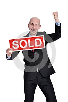 Real estate man holding a sold sign