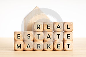 Real estate market concept. Wooden blocks with text and house icon. Copy space