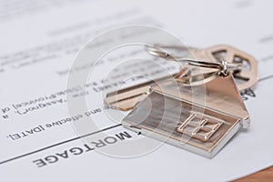 Real estate mortgage approved loan document with keys with home shaped keychain. Mortgage, investment, real estate, property and