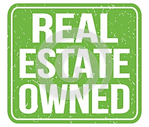 REAL ESTATE OWNED, text written on green stamp sign