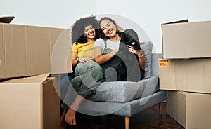 Real estate, portrait and lesbian couple with a dog on the sofa for moving boxes and a new home. Smile, lgbt and women
