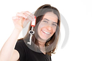 Real estate sale concept with blurry smiling woman holding home key