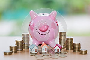 Real estate sale, home savings, piggy bank, coins and a house, l