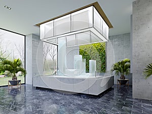 Real estate sales office with large glass building mock-up illuminated from above in modern interior