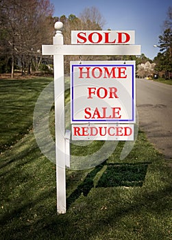 Real estate sign with sold and reduced