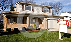 Real Estate Sold Sign In Front Of Residential Home