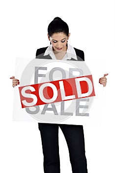 Real estate woman holding for sale - sold sign