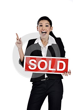 Real estate woman holding a sold sign