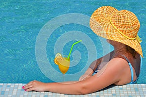 Real female beauty relaxing in swimming pool