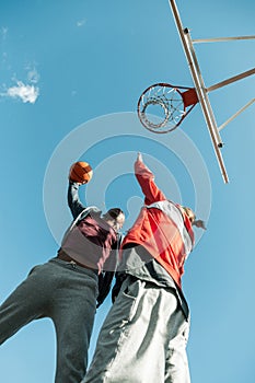 Low angle of nice young men fighting for the ball photo