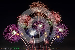 Real fireworks festival in the sky for celebration at night over the sea at coast side for new year countdown celebration