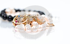 Real gold jewlery, diamonds, gems, rings, neckless with pearls close up shot photo