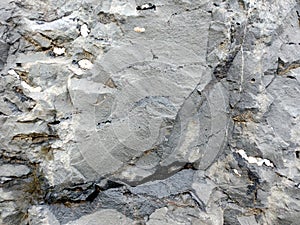 Real Grunge Rock Stone Texture. A real natural stone texture in pale blue, grey and brown ideal as a background, layer.