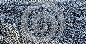 Real handmade chainmail texture close up. Background from metal rings, hauberk